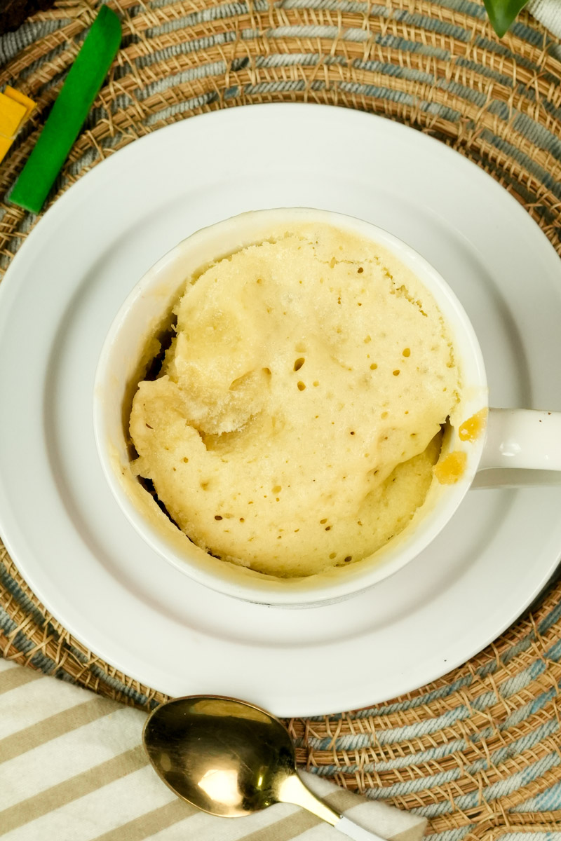 Top-down view of a soft, yellow vanilla mug cake